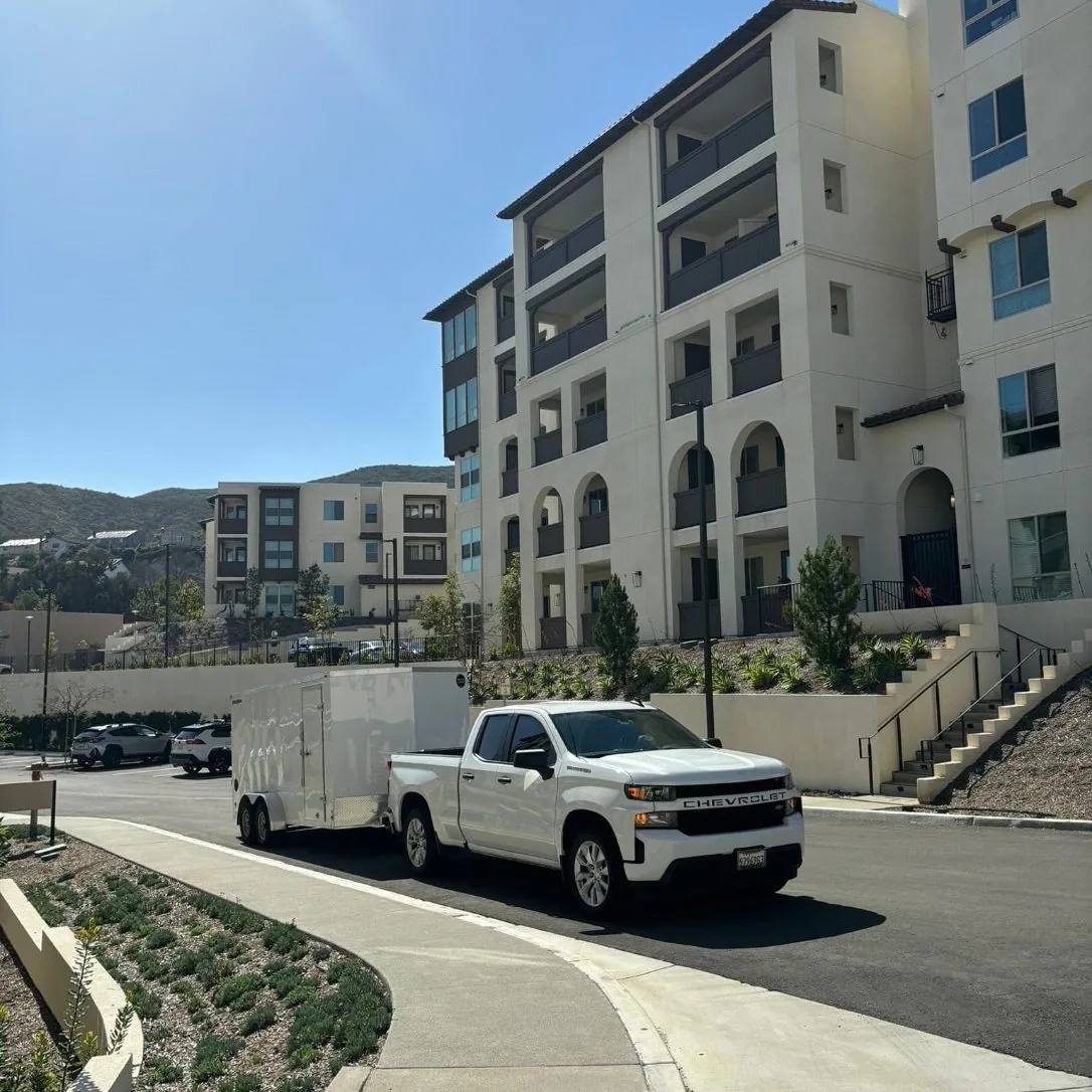 The JS pickup and enclosed trailer at a new apartment complex